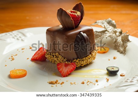 Decorated chocolate dessert on white plate