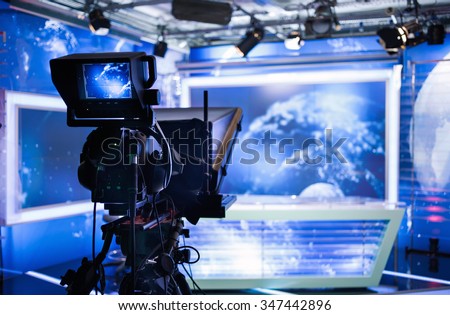Video camera - recording show in TV studio - focus on camera Royalty-Free Stock Photo #347442896