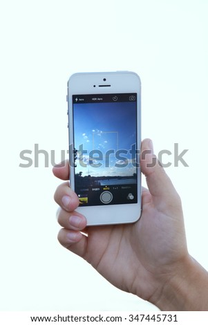 Human hand taking photo with mobile phone, outdoors