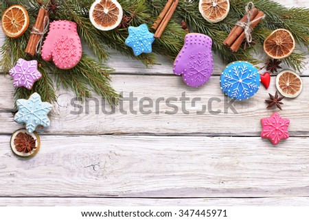 Christmas tree branch with gingerbread ,cinnamon, anise on wooden background 