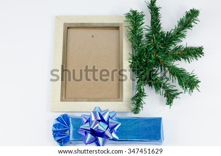Picture frame next to Christmas trees