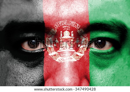 Human face painted with flag of Afghanistan.
