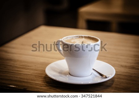Cup of Cappuccino Coffee on wooden table