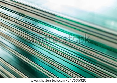 Sheets of Factory manufacturing tempered clear float glass panels cut to size Royalty-Free Stock Photo #347535320