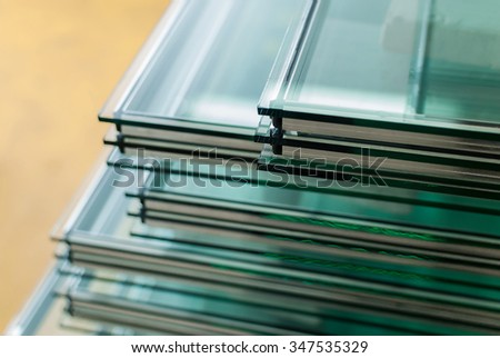 Sheets of Factory manufacturing tempered clear float glass panels cut to size Royalty-Free Stock Photo #347535329
