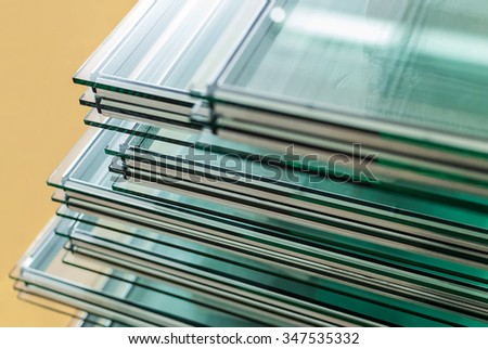 Sheets of Factory manufacturing tempered float glass panels cut to size Royalty-Free Stock Photo #347535332