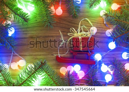 Holidays, gifts, New Year, Snow, Christmas tree with Christmas lights on the wooden background