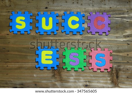 Block letters and word success on wood background