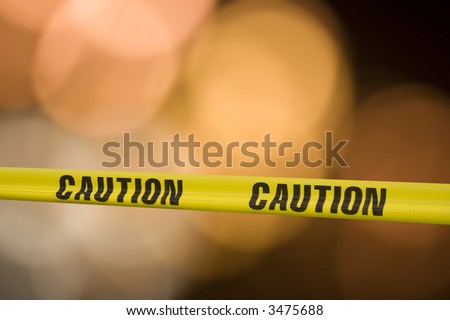 Yellow tape with the word caution on it across a warning light background Royalty-Free Stock Photo #3475688