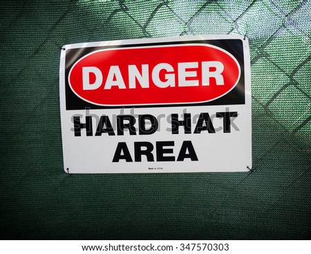  danger hard hat area sign on fence                              