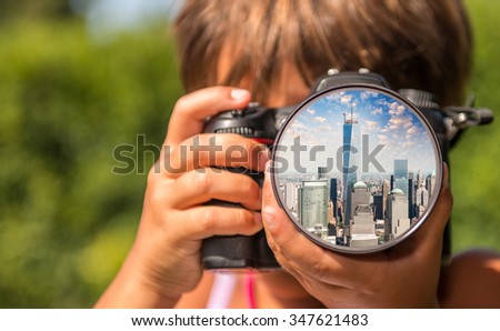 Young girl taking photos of Lower Manhattan by professional digital camera.