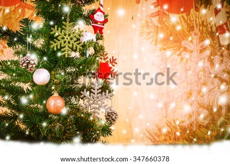Merry Christmas on snow and wooden background