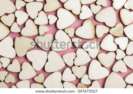 the small wooden hearts on a pink background