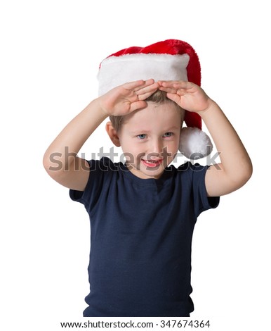 Cute three year old boy in a red cap of Santa Claus. The child merry blue eyes and blond hair soft. Photo executed on a white background
