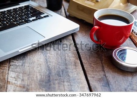 Office with laptop notepad  and coffee of cup on wood table