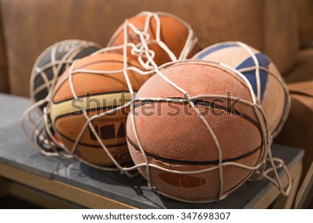 Some old vintage basket balls in a net
