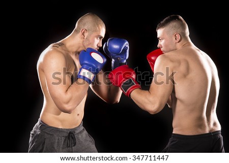 Two professional boxer isolated on black background