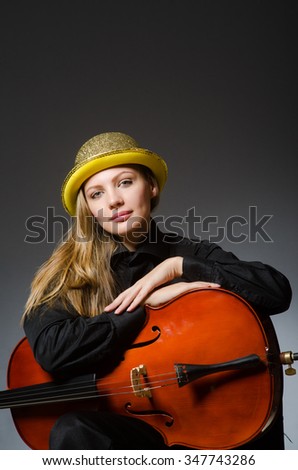 Woman playing classical cello in music concept