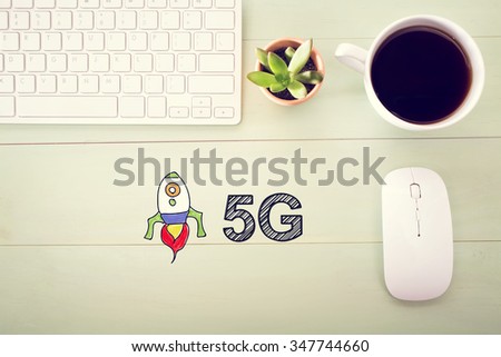 5G concept concept with workstation on a light green wooden desk