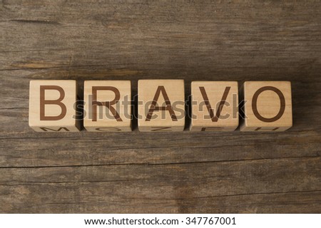 BRAVO text on a wooden background