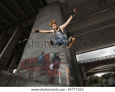 Wide angle shot of a jumping rollerskater on a dark urban background - with just a little motion blur