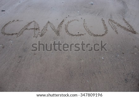 Inscription on the sand "Cancun".