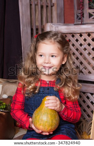 Cheerful beautiful girl with a pumpkin in the hands