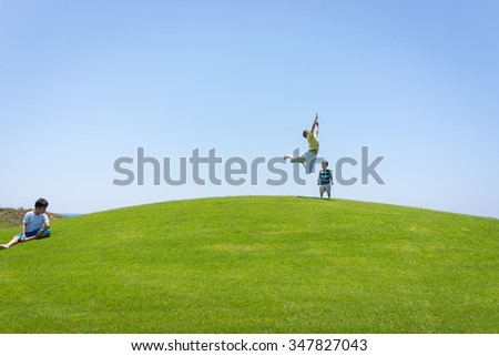 Kid jumping on beautiful field