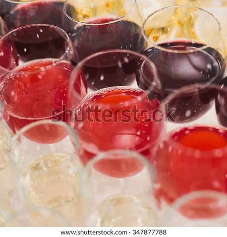 Beautiful row line of different colored alcohol cocktails with mint on a christmas party, martini, vodka with bubbles, wine and others on decorated catering bouquet table on open air event, picture 