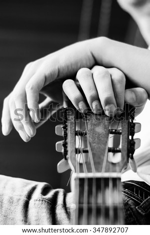 Guitar instrument. Musician or guitarist. Music, musical sound. Finger, hand on string. Acoustic concert closeup. Player play chord. Wood jazz, rock performance. Fretboard. 