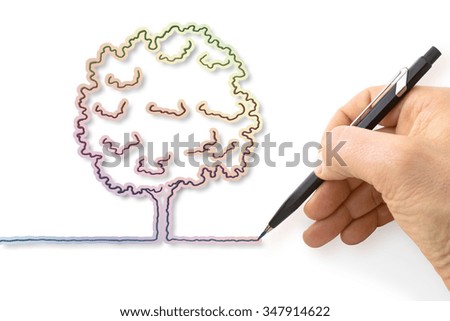 Hand draws a colorful tree - concept image