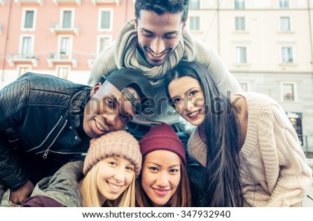 Group of friends taking selfie. Multiracial group putting faces together and take photos