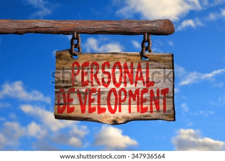 Personal development motivational phrase sign on old wood with blurred background
