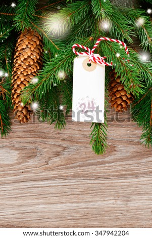 fresh  fir tree with merry christmas tag for 24 december