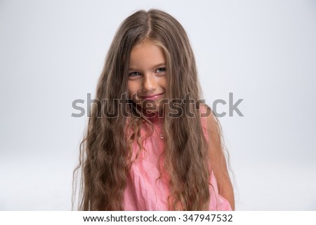 Portrait of a pretty little girl standing isolated on a white background