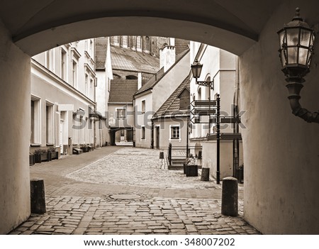 Medieval yard in old Riga city - capital and largest city of Latvia, a major commercial, cultural, historical and financial center of the Baltic region  Image toned for inspiration of retro style