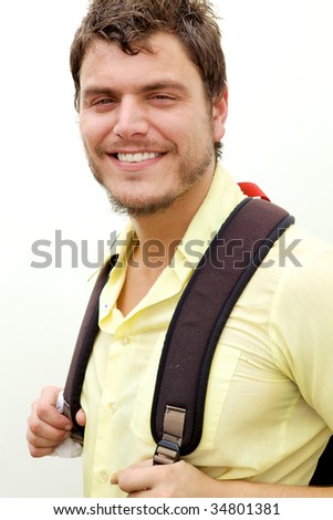 A young man with a knapsack smiling