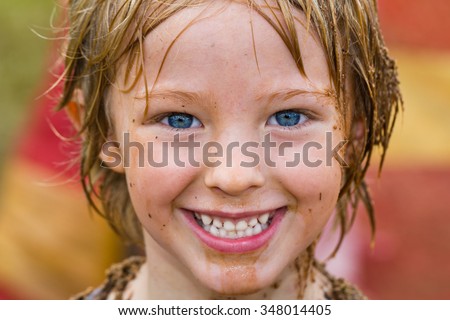 Close up portrait of happy muddy boy with dirty face outdoors Royalty-Free Stock Photo #348014405