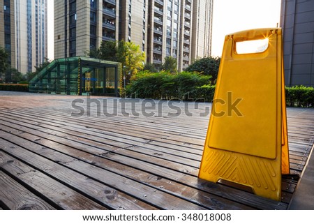 yellow parking card stands on wooden floor front of residential buildings