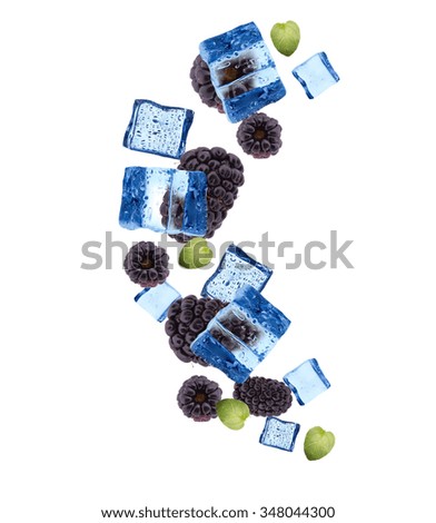 Fruits in ice cubes isolated on white background. Fresh blackberries