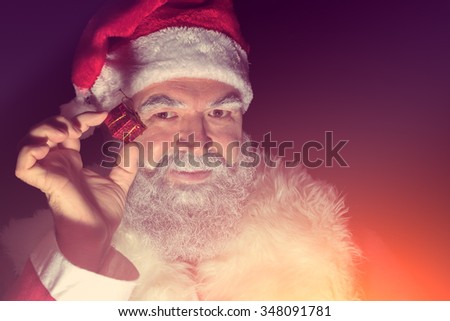 Santa Claus with a very small gift