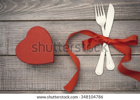 Silverware and chocolate box on the wooden plank