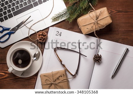 Notebook with cup of coffee on wooden background