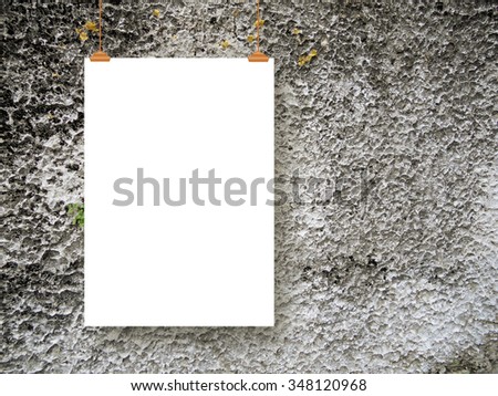 Single hanged paper sheet frame with brown clips on concrete wall background