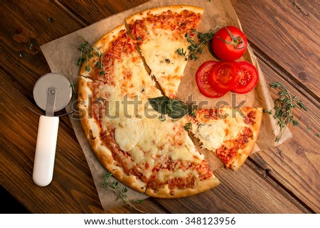 Appetizing Pizza Margherita with tomatoes on baking paper