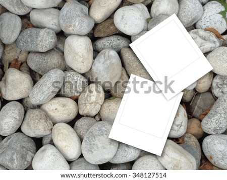 Two square frames on grey pebbles background