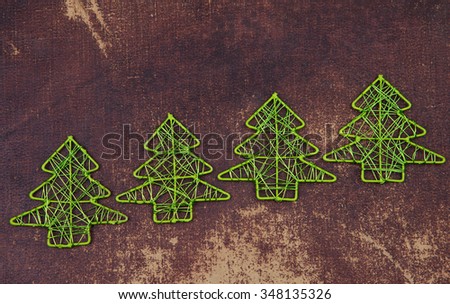 Green christmas tree figures  made out of wire  on a grunge background