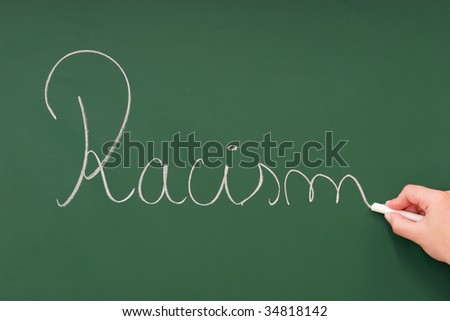 Racism written on a blackboard with chalk