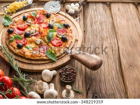 Pizza with mushrooms, salami and tomatoes. Top view.