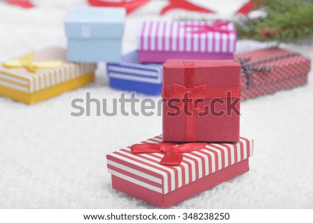 Red Christmas present on white background with Christmas tree and red ribbon.